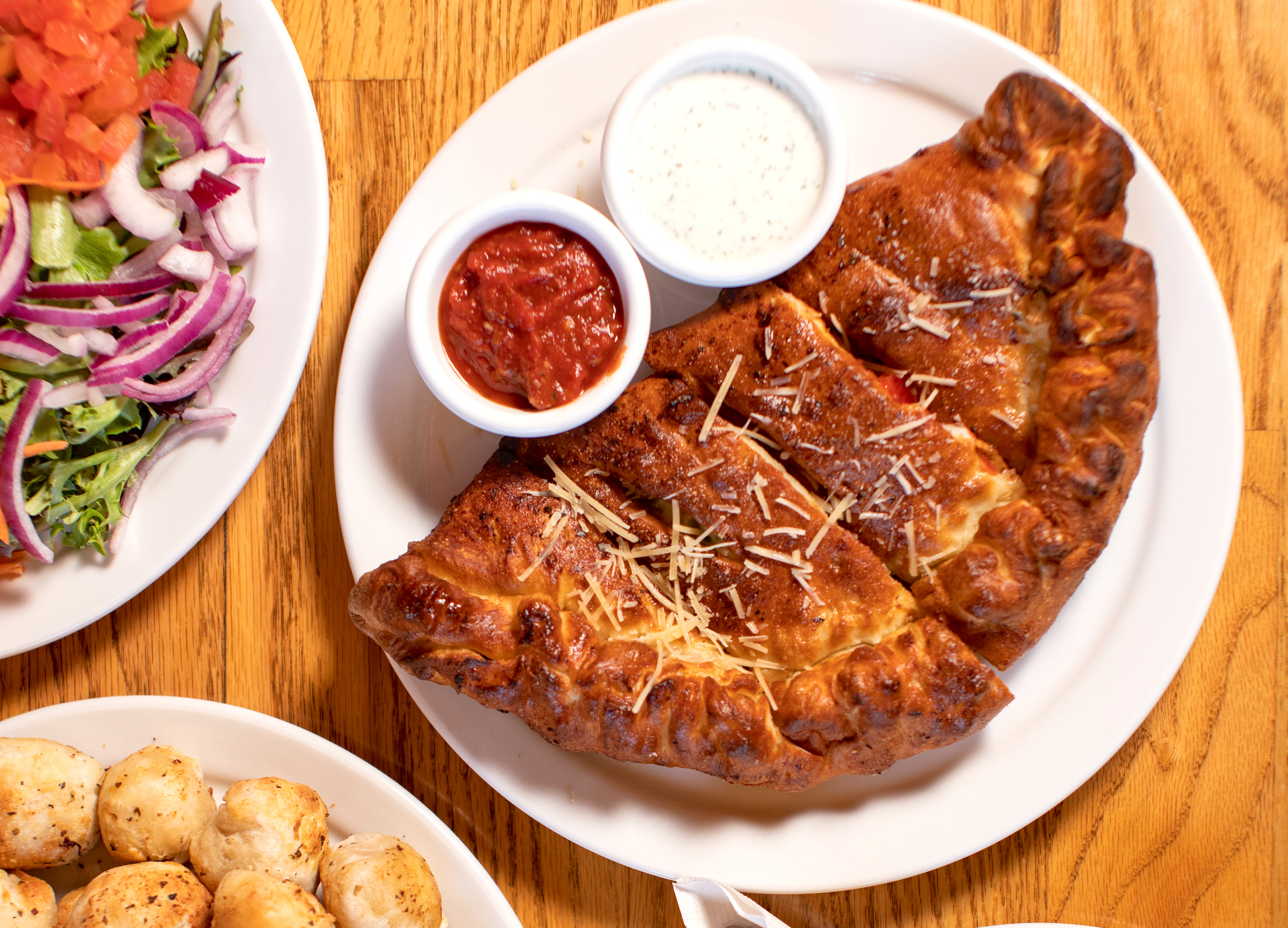 Calzone with dipping sauces and cheese balls